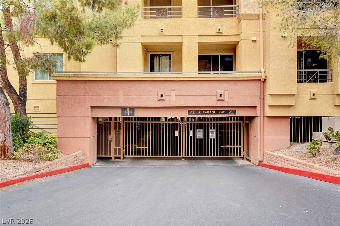 230 East Flamingo Road, Unit 106 Las Vegas, NV 89169 - Photo 34 of 66 Secure gated entry welcomes you to this multi-story residence with convenient ground-level parking.