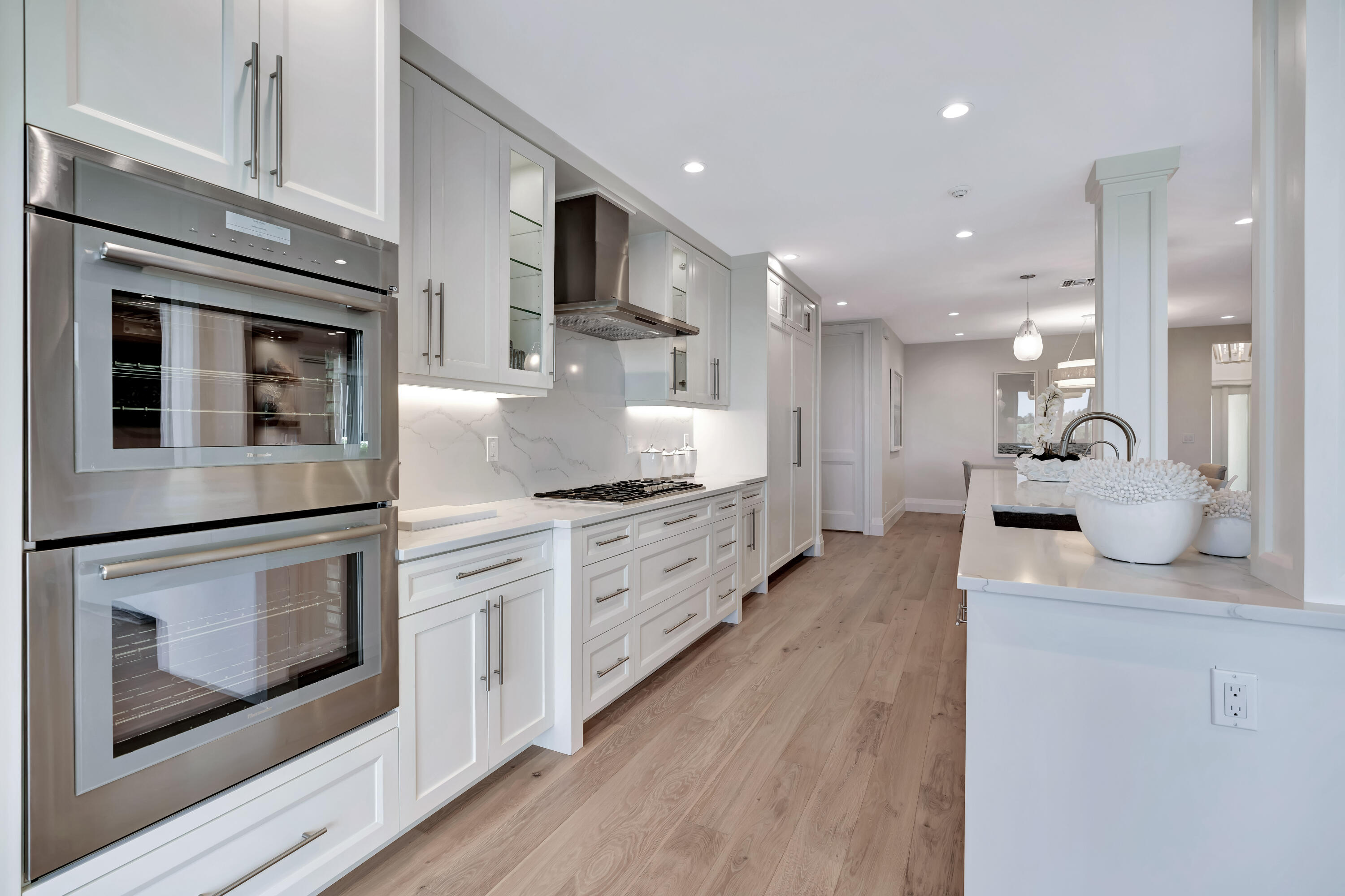260 Eagle Drive Jupiter, FL 33477 - Photo 15 of 41 a kitchen with stainless steel appliances kitchen island granite countertop a stove top oven and sink