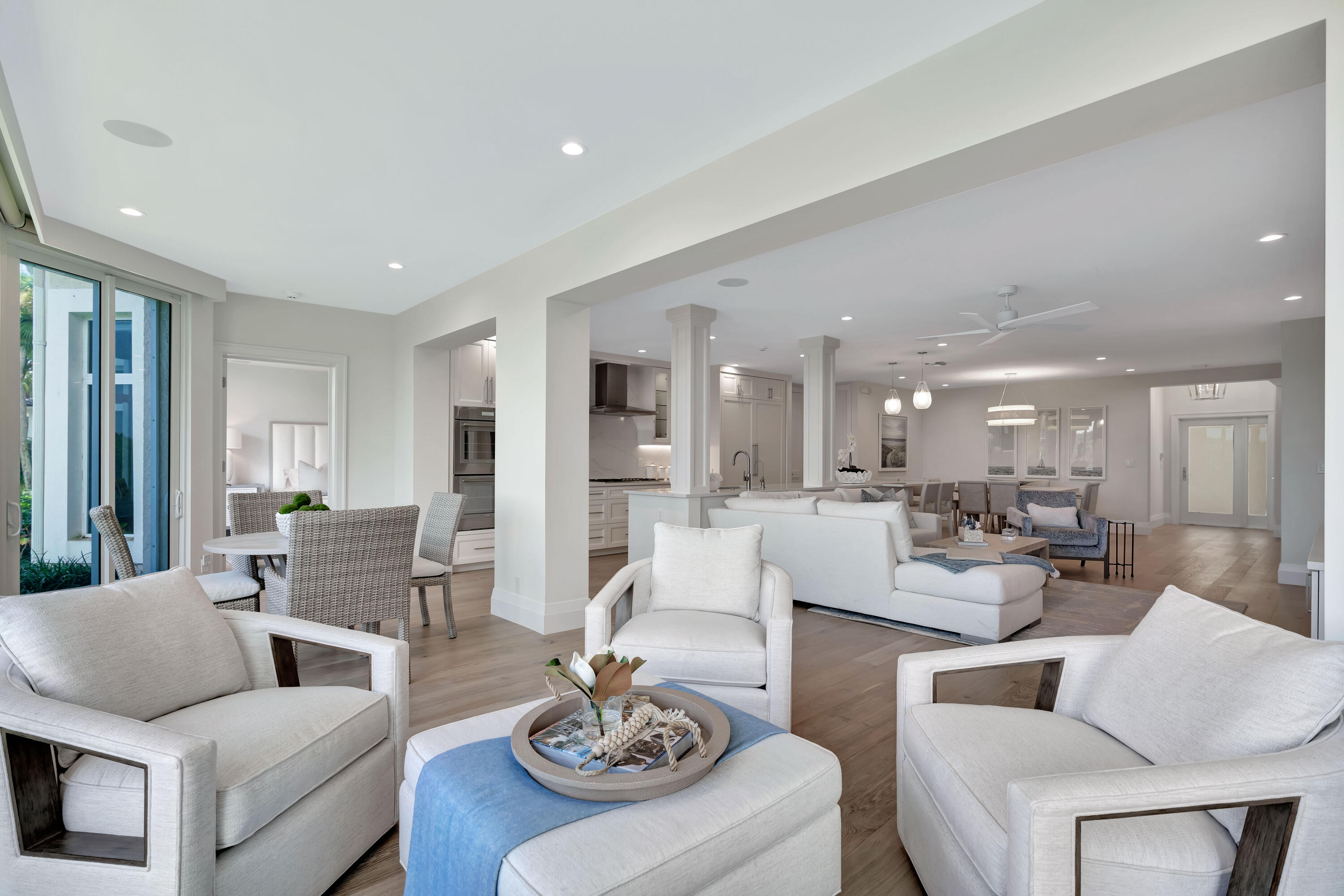 260 Eagle Drive Jupiter, FL 33477 - Photo 20 of 41 a living room with furniture and a dining table with wooden floor