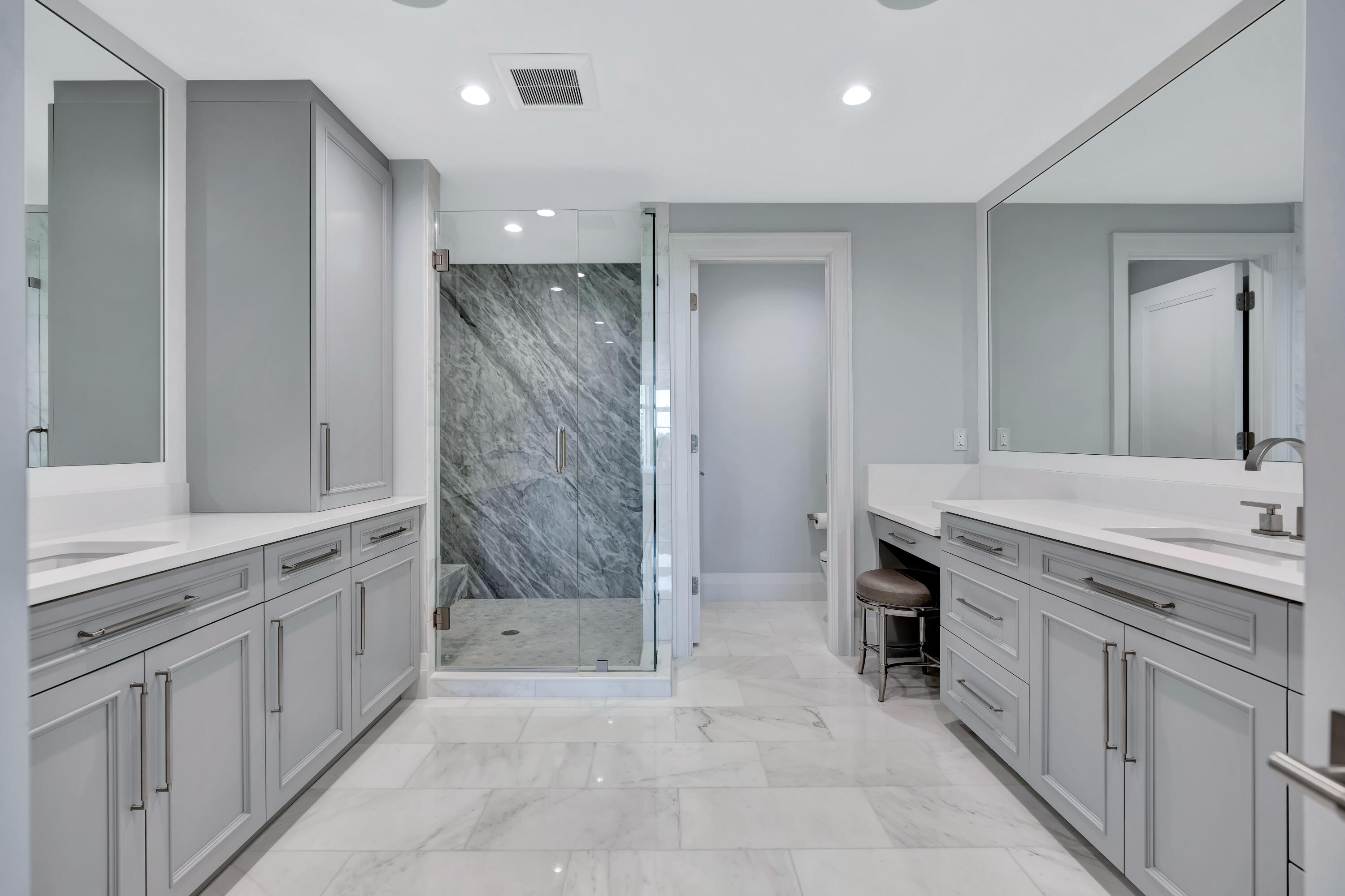 260 Eagle Drive Jupiter, FL 33477 - Photo 24 of 41 a bathroom with a granite countertop sink a mirror and a shower