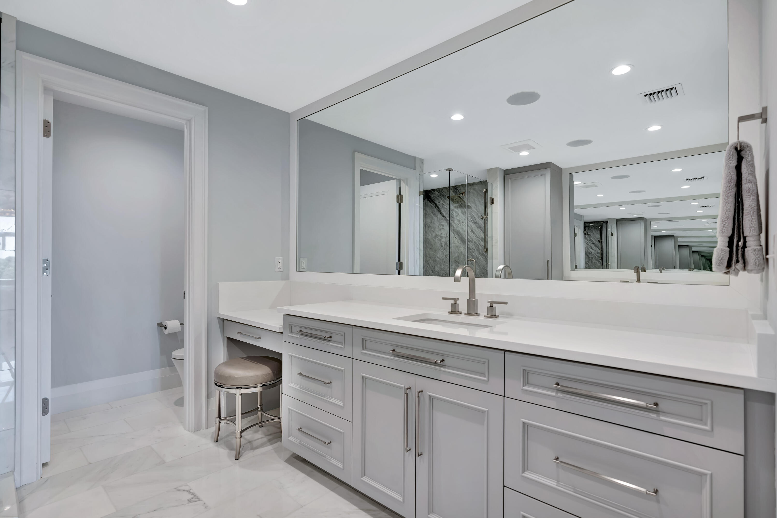 260 Eagle Drive Jupiter, FL 33477 - Photo 25 of 41 a bathroom with a double vanity sink and a mirror