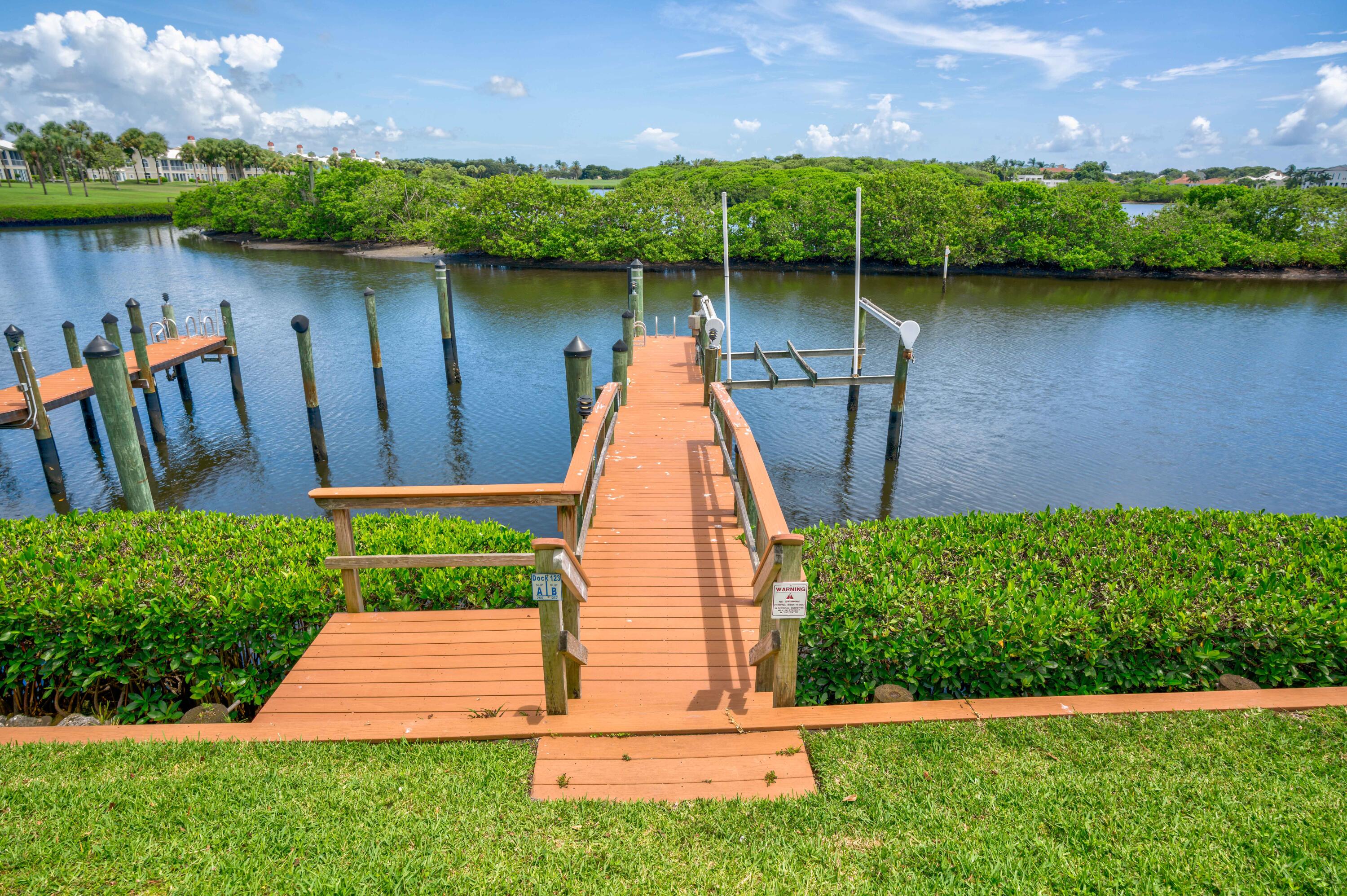 260 Eagle Drive Jupiter, FL 33477 - Photo 34 of 41 a view of a backyard with plants and a lake