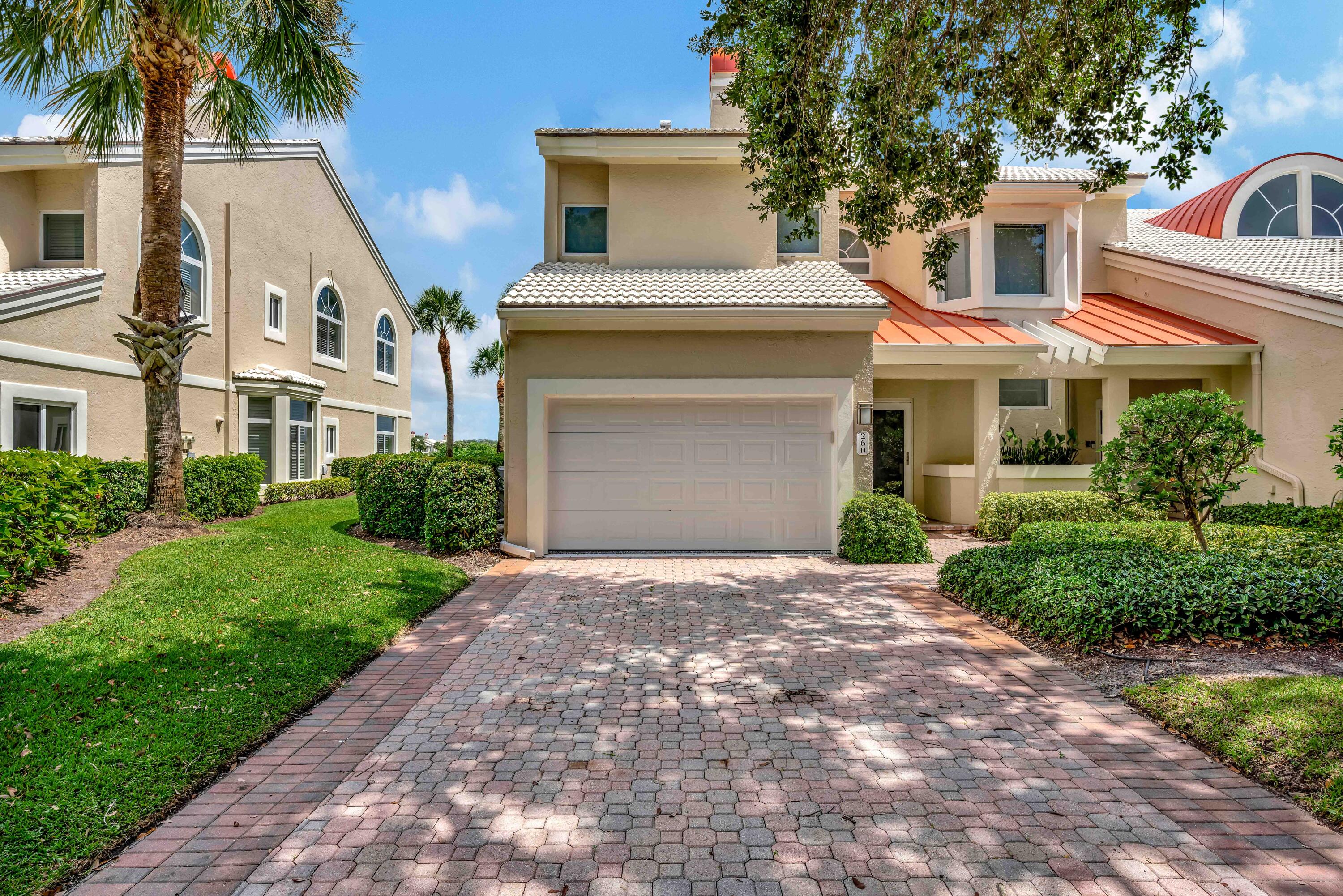 260 Eagle Drive Jupiter, FL 33477 - Photo 38 of 41 a front view of a house with a garden