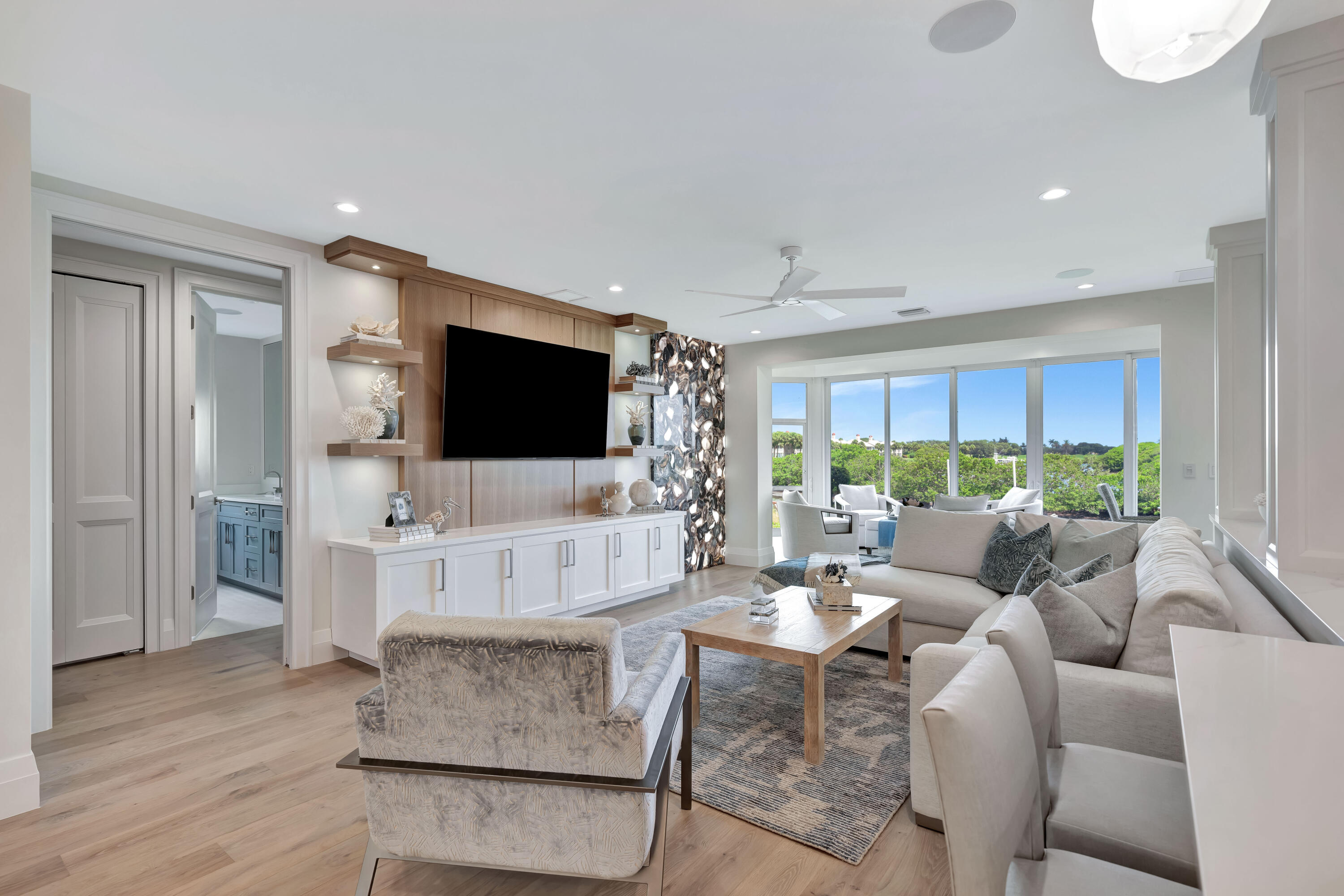 260 Eagle Drive Jupiter, FL 33477 - Photo 7 of 41 a living room with furniture a flat screen tv and a large window