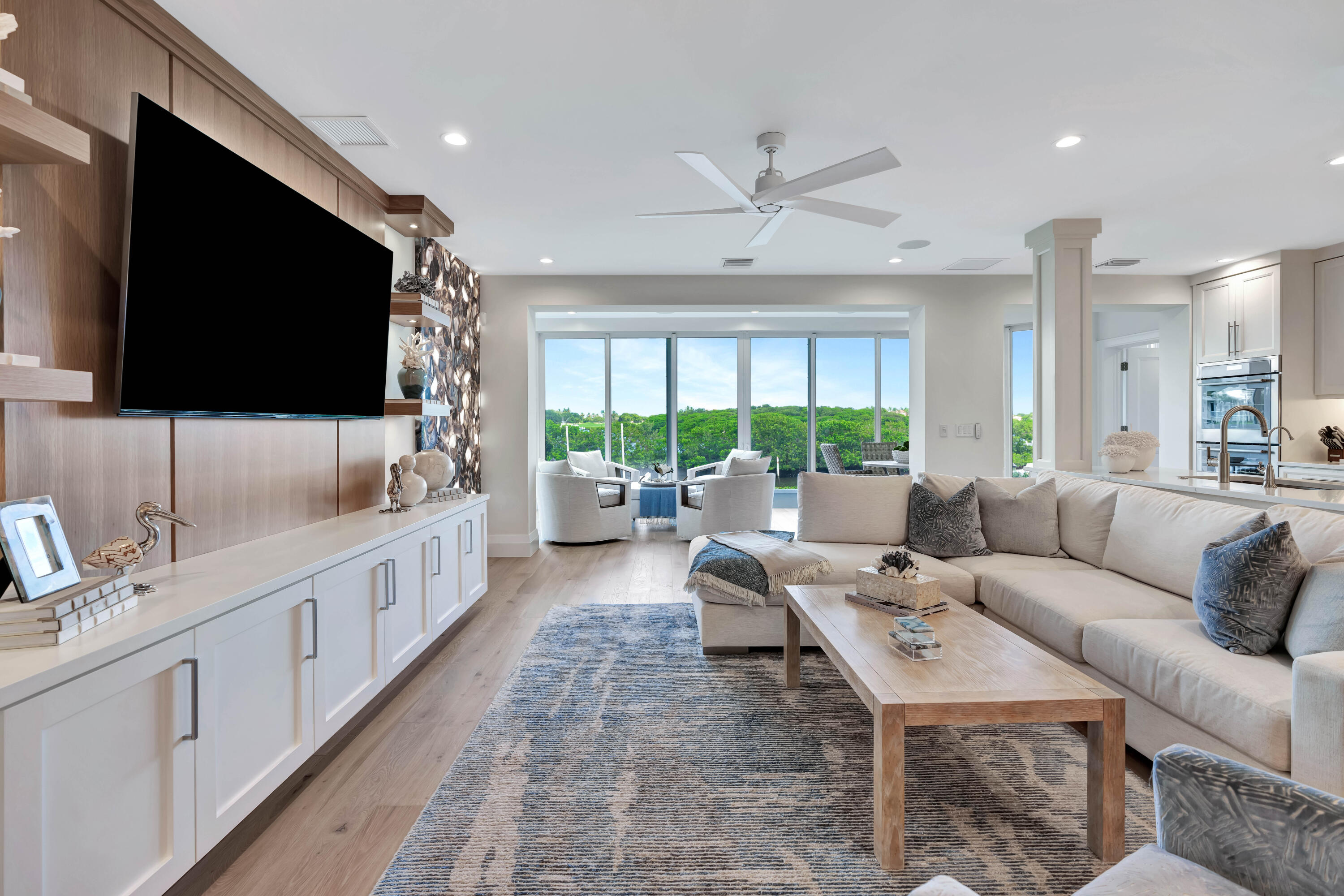260 Eagle Drive Jupiter, FL 33477 - Photo 8 of 41 a living room with furniture a flat screen tv and a large window