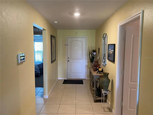 a kitchen with a table chairs refrigerator and microwave