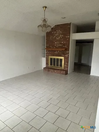 a view of a livingroom with an empty space and a fireplace