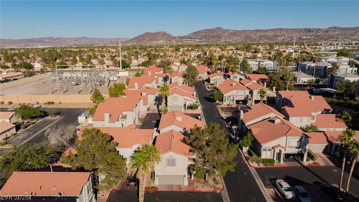 2246 Ramsgate Drive Henderson, NV 89074 - Photo 33 of 36 An aerial perspective reveals a vibrant community with terracotta rooftops against a desert mountain backdrop.