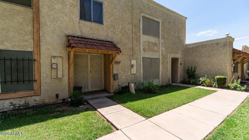 a front view of a house with a garden