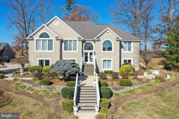 a living room with furniture a fireplace and a chandelier