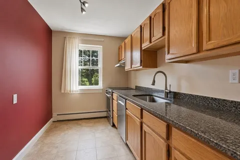 a kitchen that has a sink and a stove