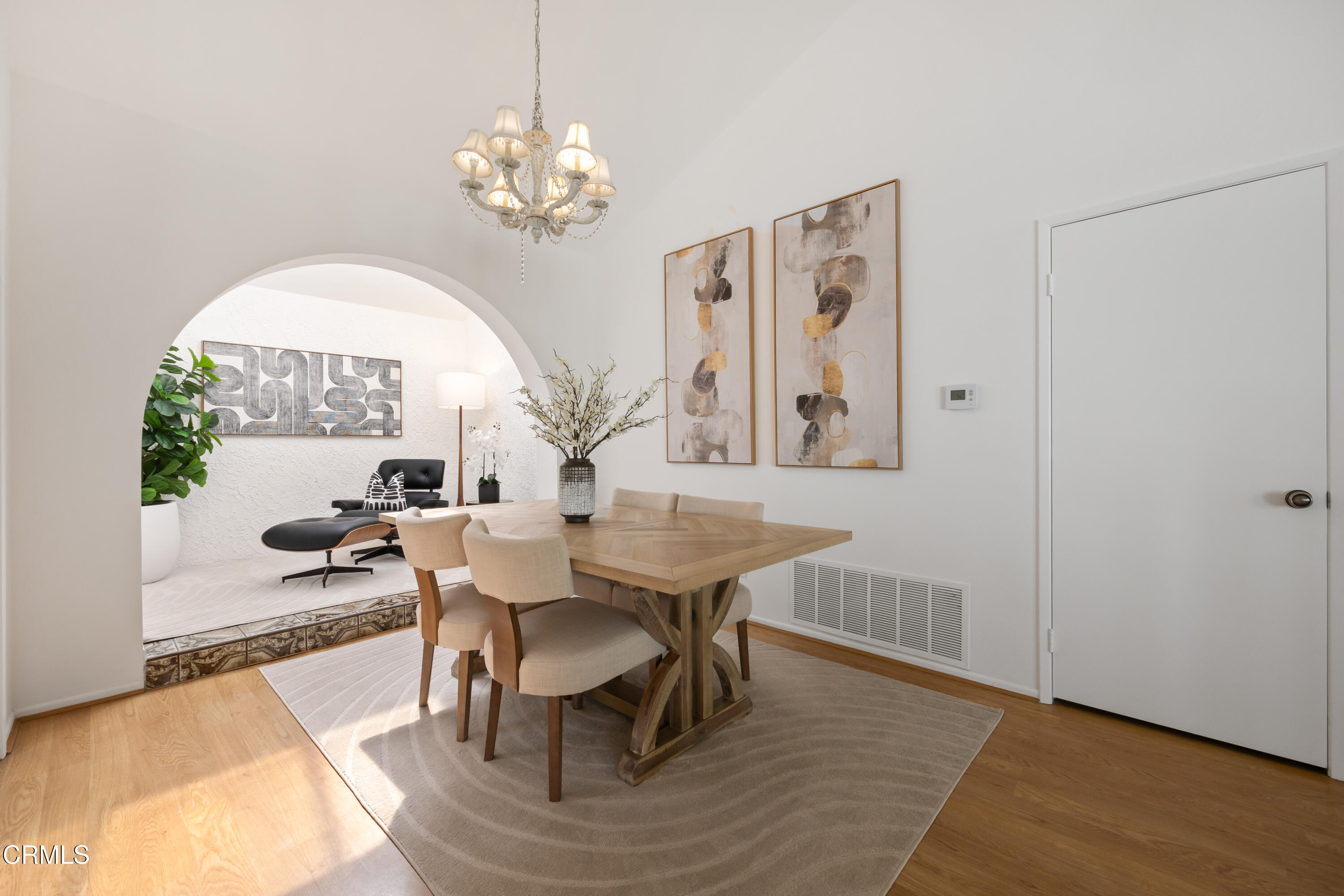 6464 Melray Street Moorpark, CA 93021 - Photo 14 of 57 a view of a dining room with furniture a chandelier and wooden floor