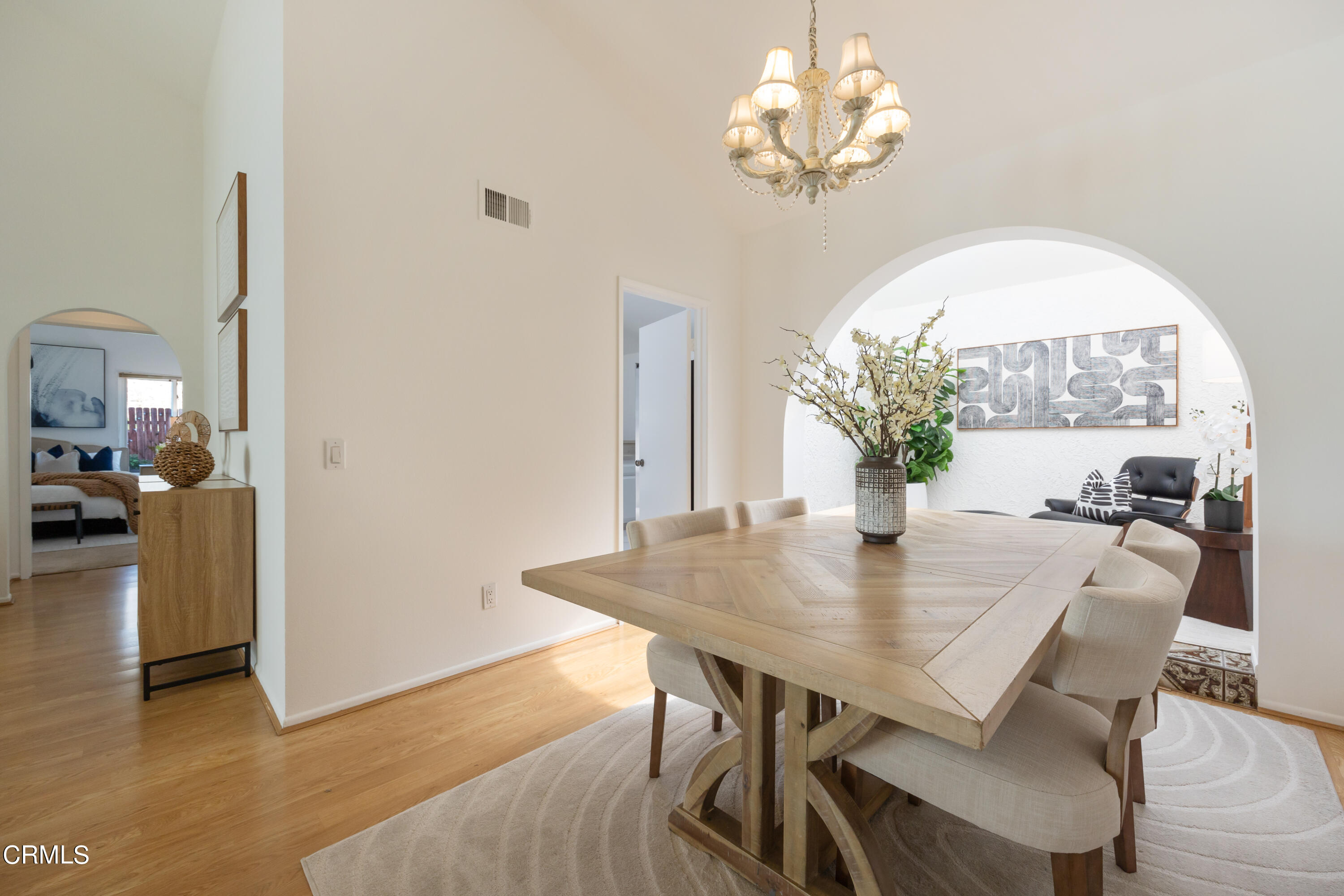 6464 Melray Street Moorpark, CA 93021 - Photo 16 of 57 a view of a dining room with furniture a chandelier and wooden floor