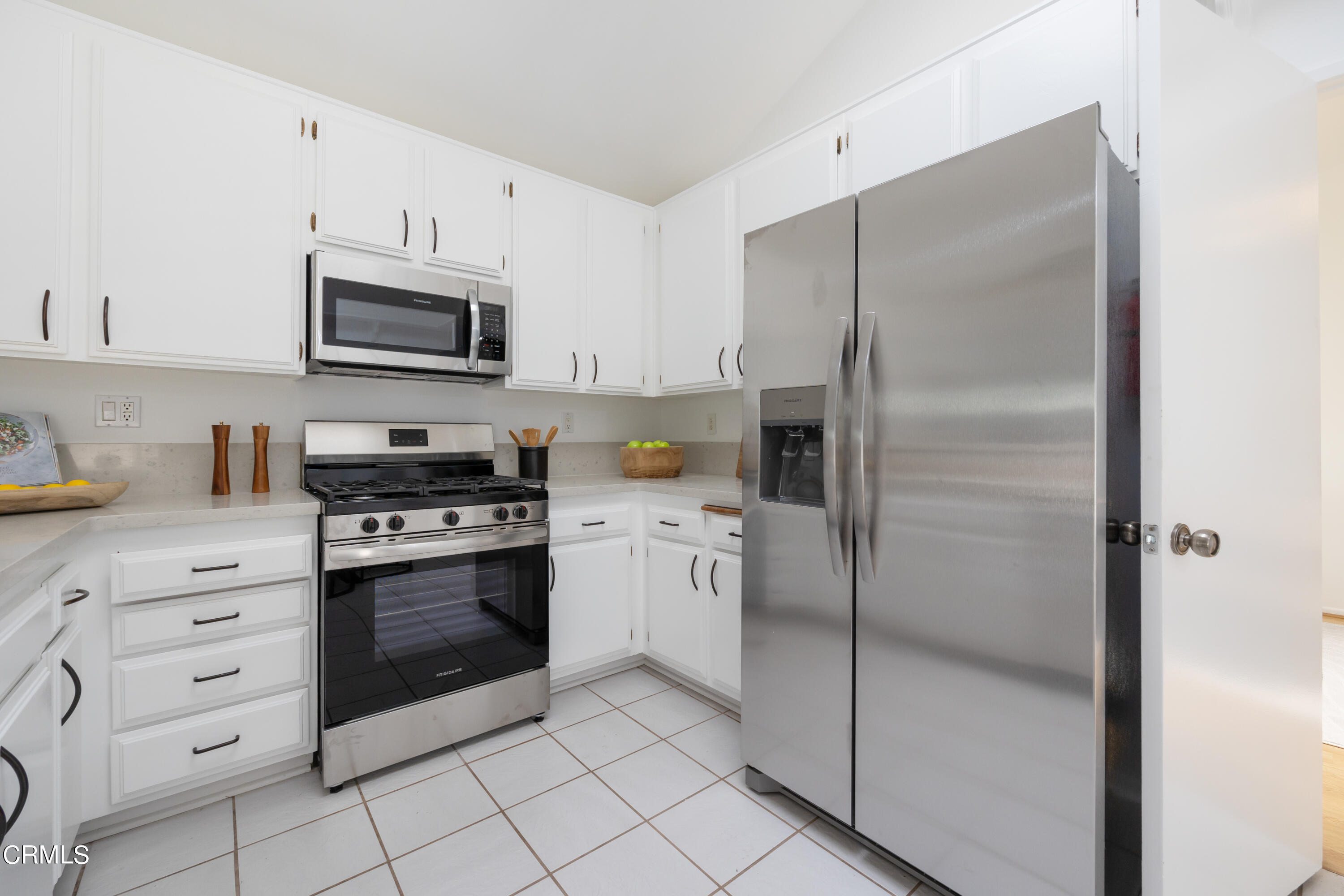 6464 Melray Street Moorpark, CA 93021 - Photo 25 of 57 a kitchen with cabinets stainless steel appliances and a counter space