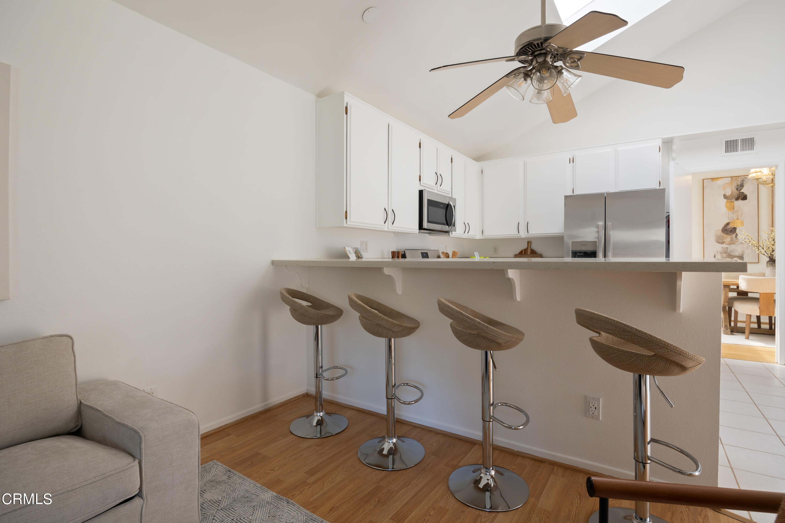 6464 Melray Street Moorpark, CA 93021 - Photo 30 of 57 a kitchen with stainless steel appliances granite countertop a sink a stove a dining table and chairs