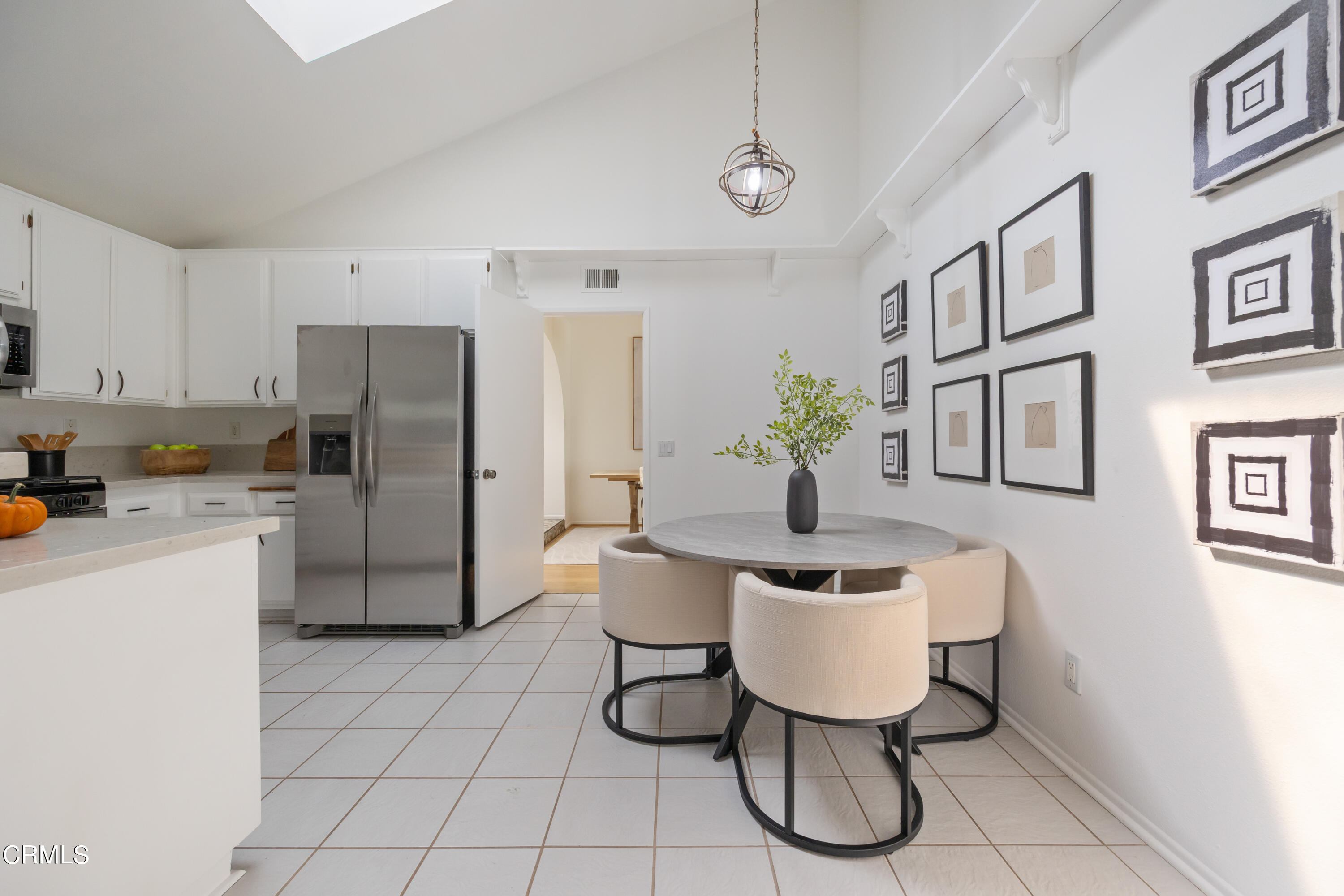 6464 Melray Street Moorpark, CA 93021 - Photo 34 of 57 a kitchen with stainless steel appliances granite countertop a refrigerator a sink a dining table and chairs