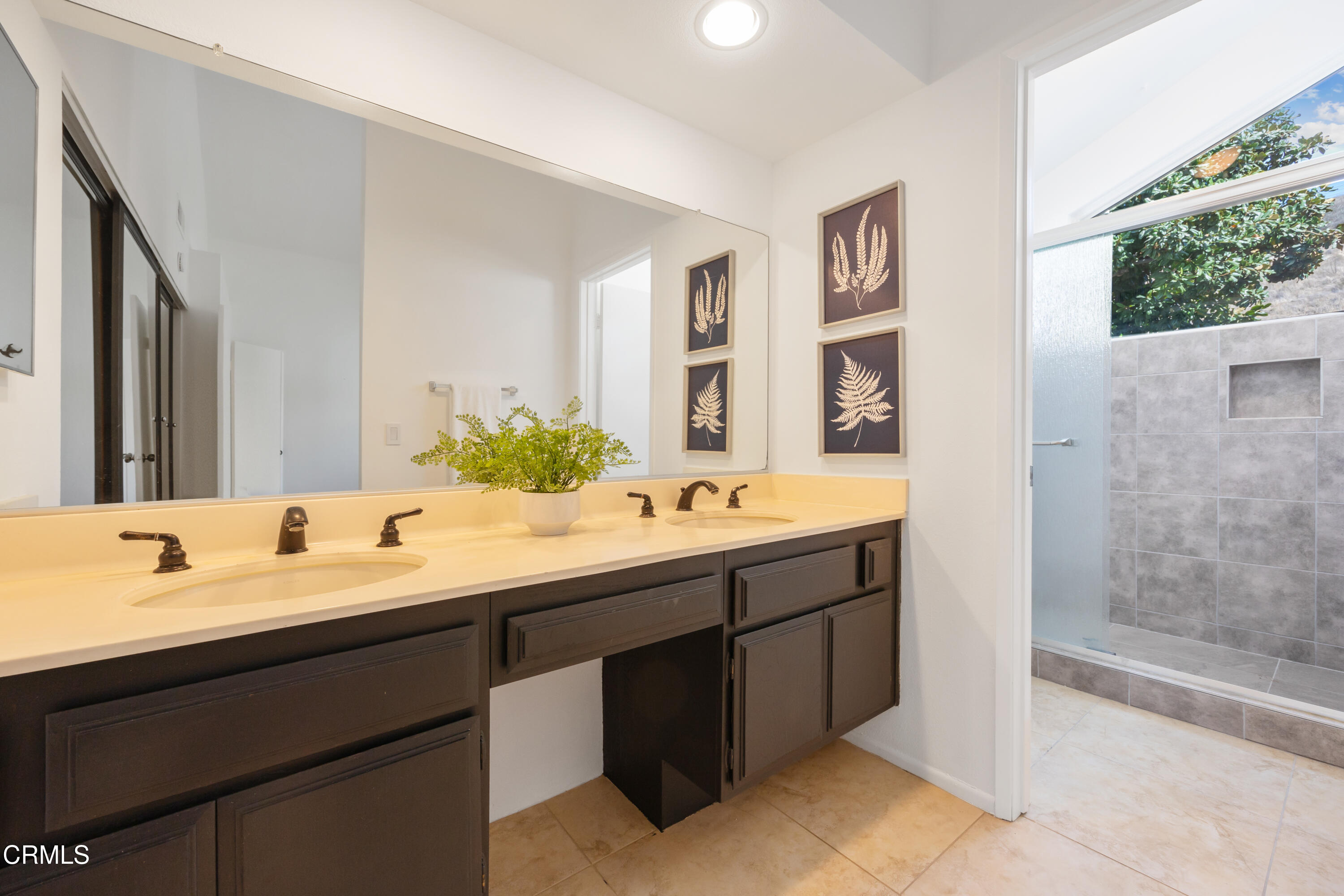 6464 Melray Street Moorpark, CA 93021 - Photo 40 of 57 a bathroom with a double vanity sink mirror and shower