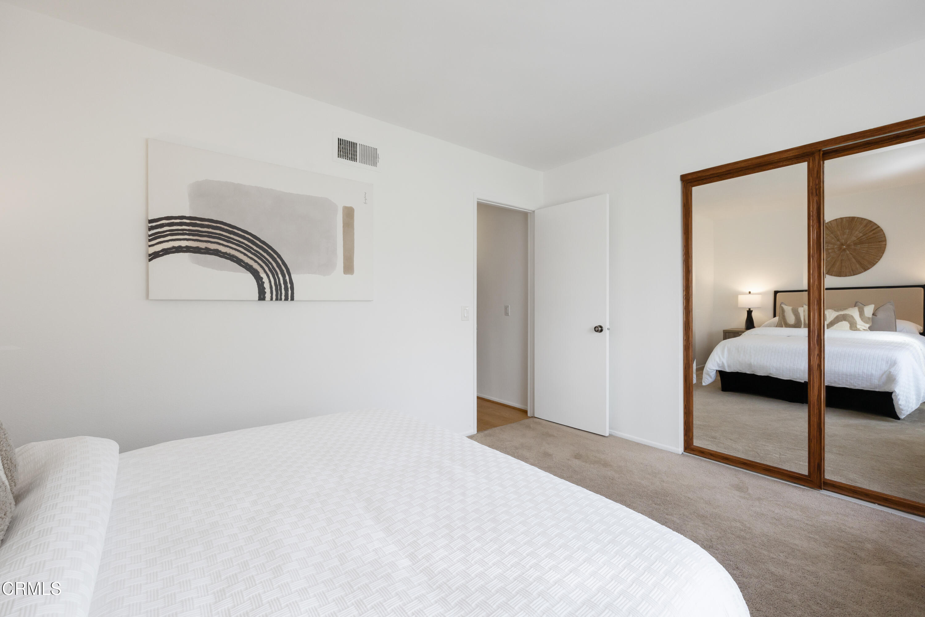 6464 Melray Street Moorpark, CA 93021 - Photo 51 of 57 a bedroom with a bed and a mirror
