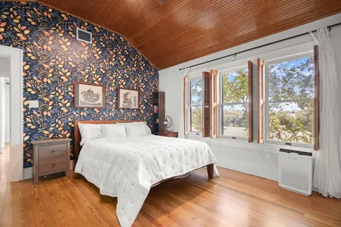 a bedroom with a large bed and a large window