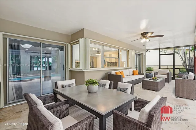 a living room with furniture a chandelier and a table