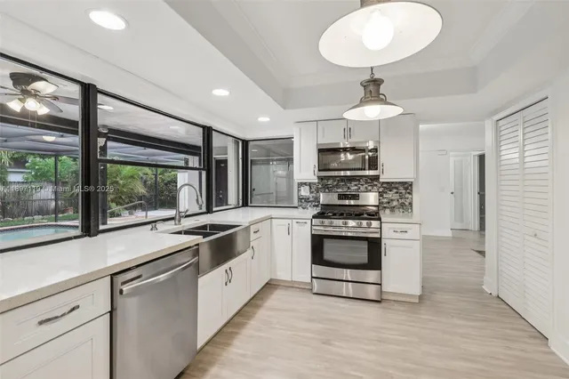 a kitchen with a sink and large window
