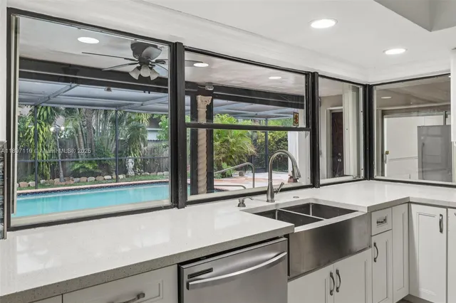 a kitchen with stainless steel appliances granite countertop a refrigerator a stove a sink dishwasher a oven with a dining table and chairs