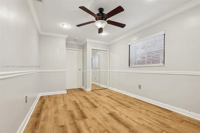 a view of empty room with wooden floor