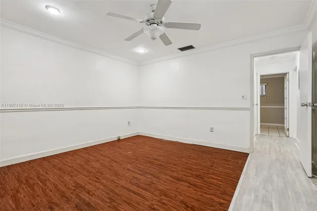 a view of walk in closet with wooden floor