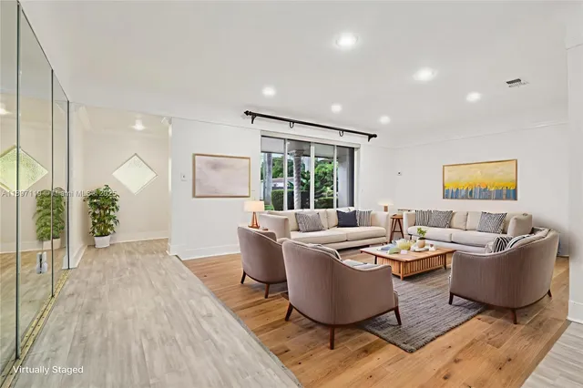 a living room with furniture and a large window
