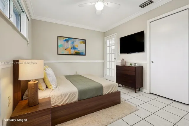 a bedroom with a bed and a television