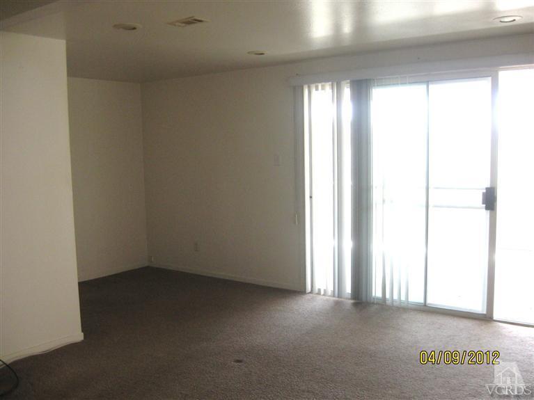 1408 West Guava Street Oxnard, CA 93033 - Photo 4 of 9 an empty room with a empty space and windows