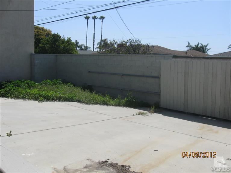 1408 West Guava Street Oxnard, CA 93033 - Photo 8 of 9 a view of wooden floor and a bench in a backyard