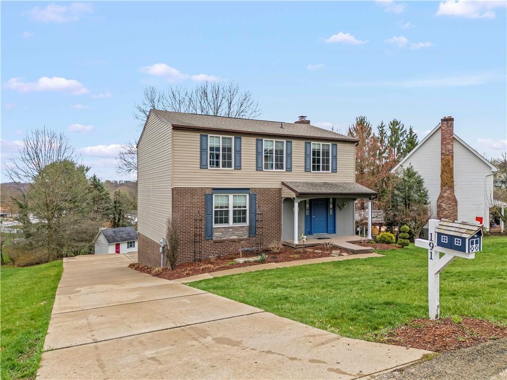 191 Deer Drive Washington, PA 15301 - Photo 2 of 33 a front view of a house with a garden and plants