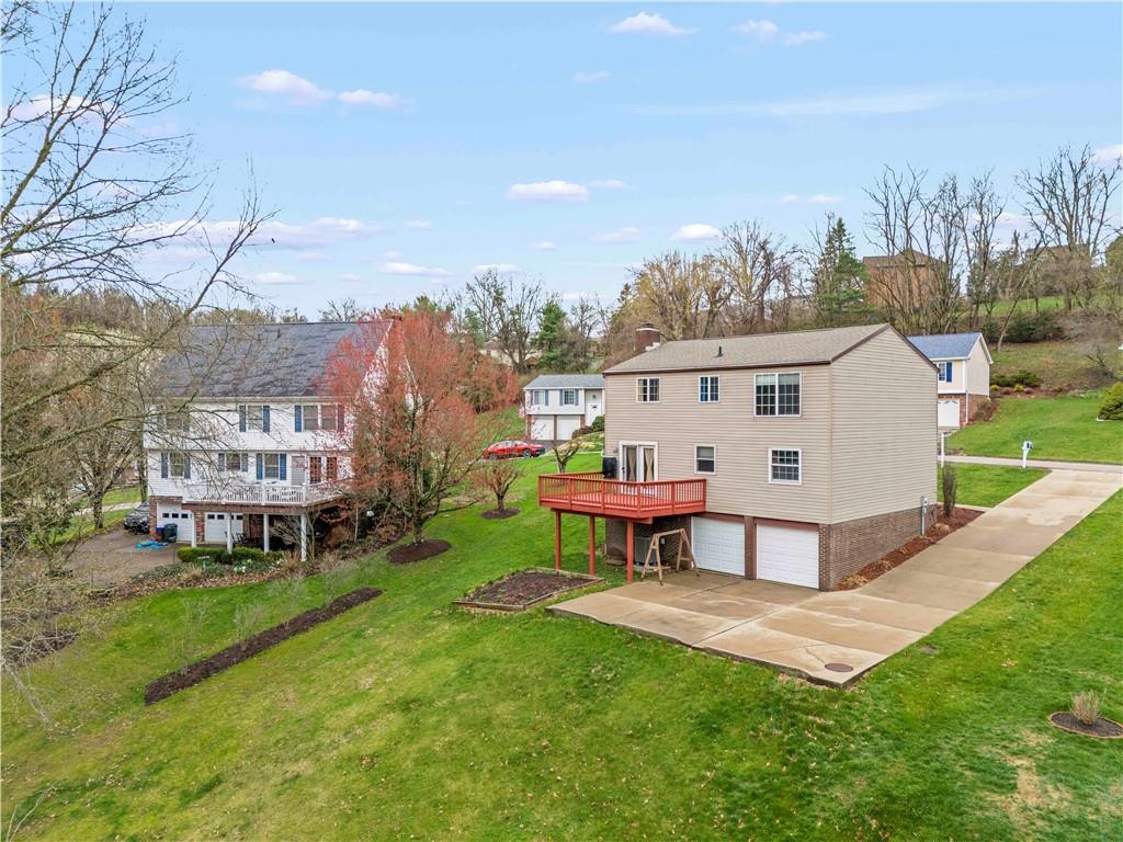 191 Deer Drive Washington, PA 15301 - Photo 31 of 33 a view of a white house in a big yard with table and chairs plants and large trees