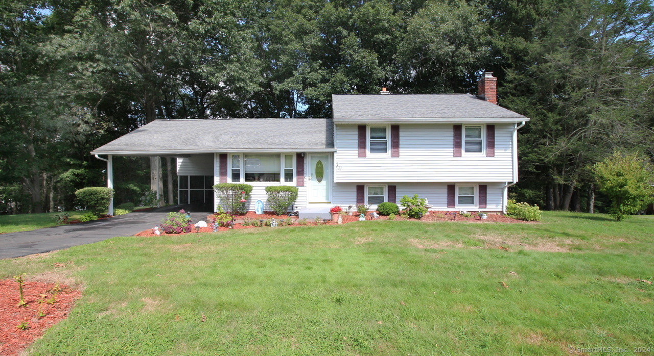 22 Laurel Drive Wallingford, CT 06492 - Photo 1 of 1 a front view of a house with a garden and porch