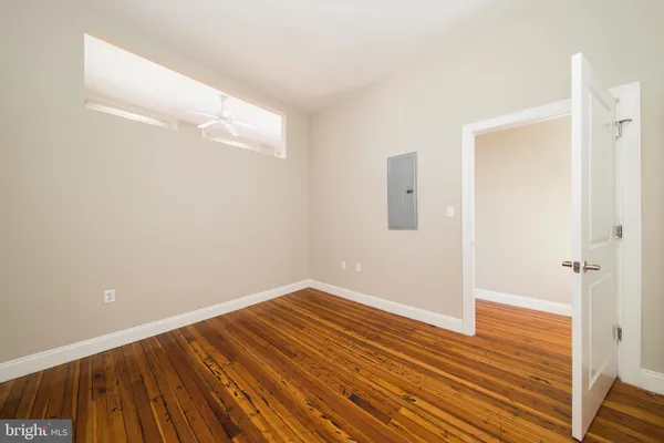 a view of a room with wooden floor and staircase