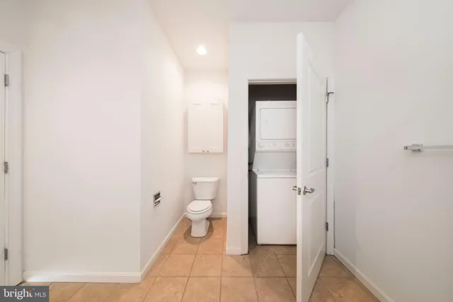 a bathroom with a granite countertop sink a mirror and a bathtub