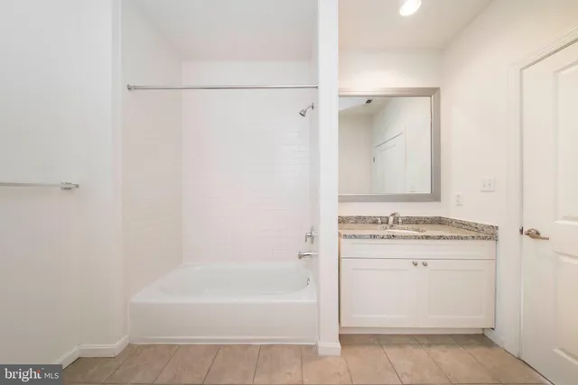 a view of a kitchen with wooden floor and a window