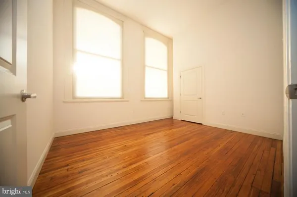 a view of a kitchen with wooden floor and a window
