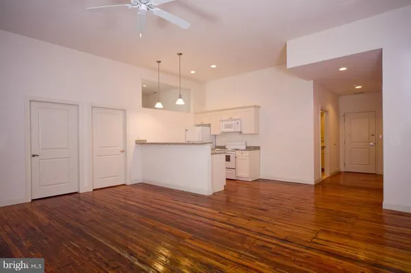 a kitchen with a refrigerator and a stove top oven