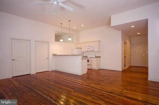 a kitchen with a refrigerator and a stove top oven