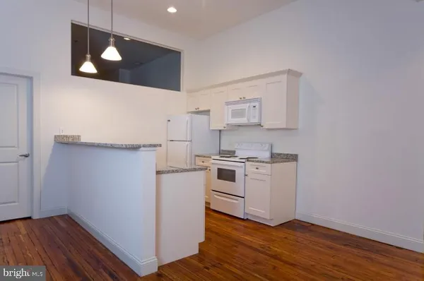 a view of a kitchen with wooden floor