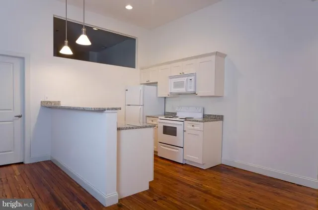 a view of a kitchen with wooden floor
