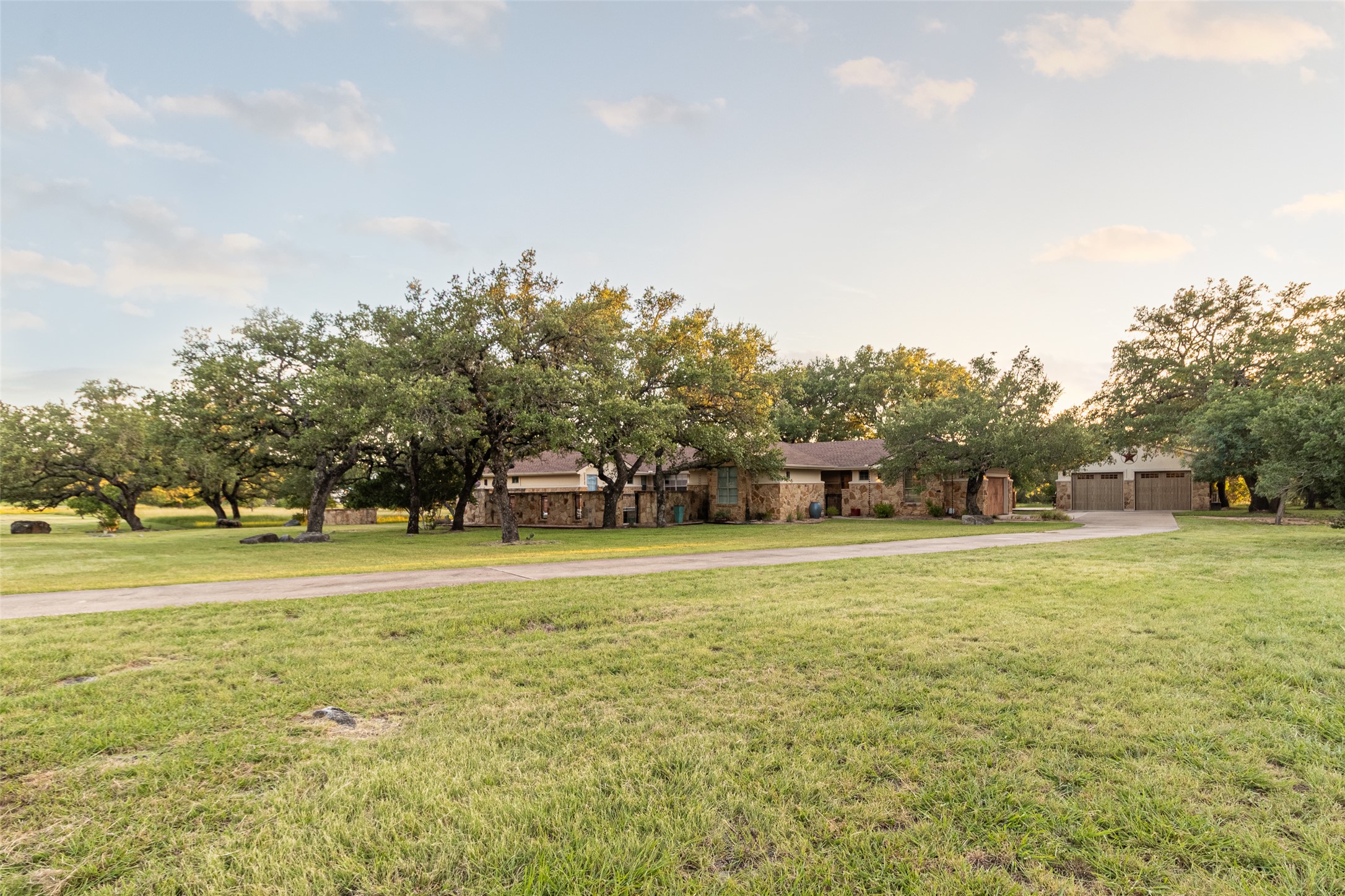 515 E Trail Spicewood, TX 78669 - Photo 12 of 36 a view of a big yard with and trees