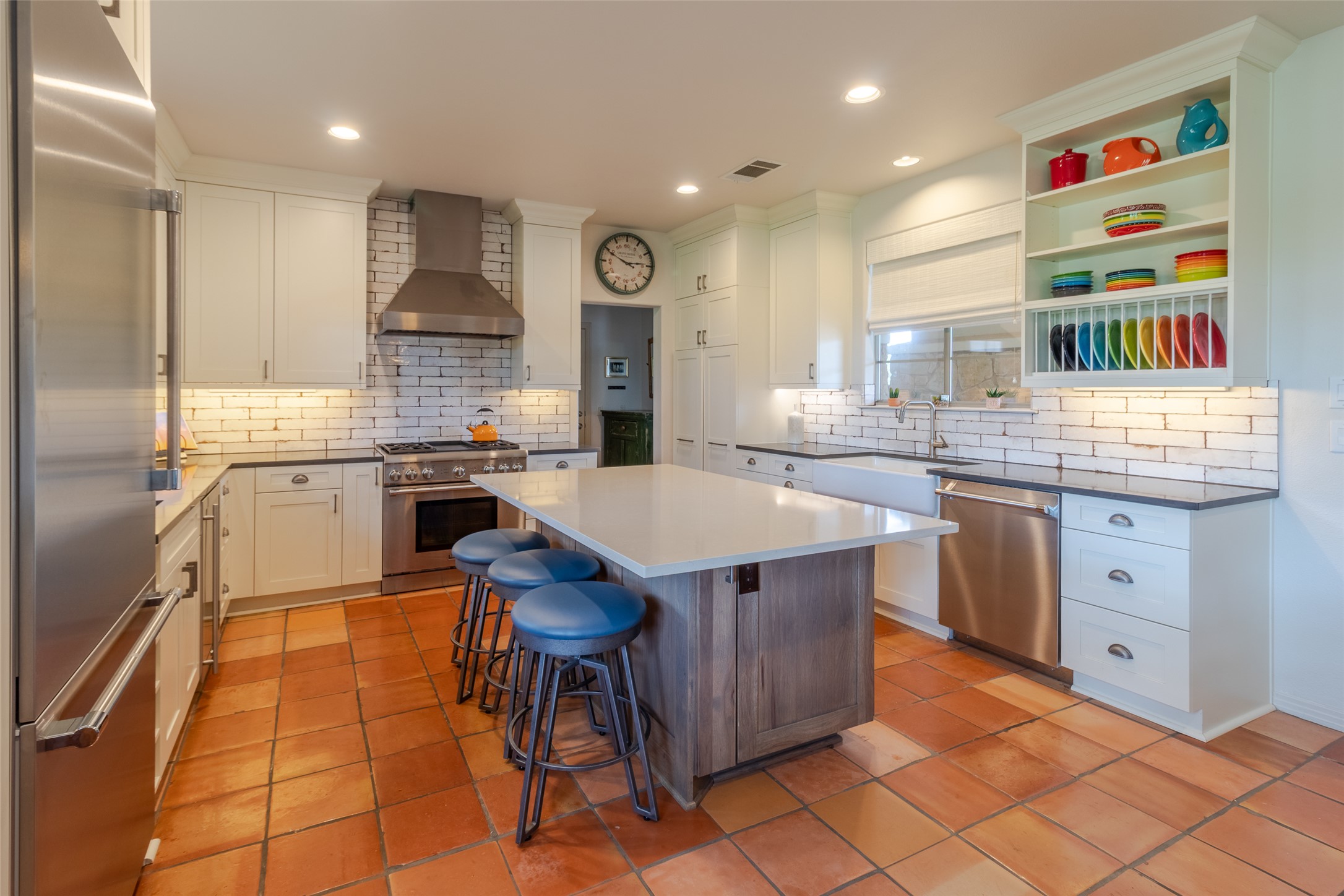 515 E Trail Spicewood, TX 78669 - Photo 15 of 36 a kitchen with kitchen island a sink stove and cabinets