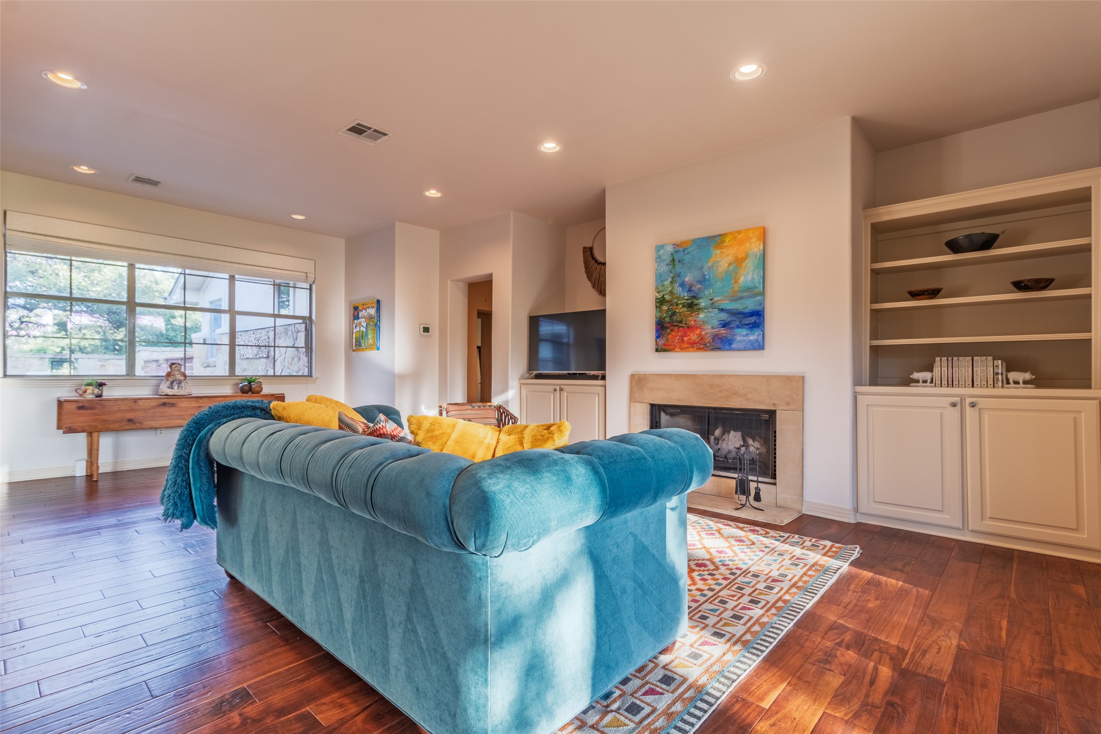 515 E Trail Spicewood, TX 78669 - Photo 17 of 36 a living room with fireplace furniture and a wooden floor