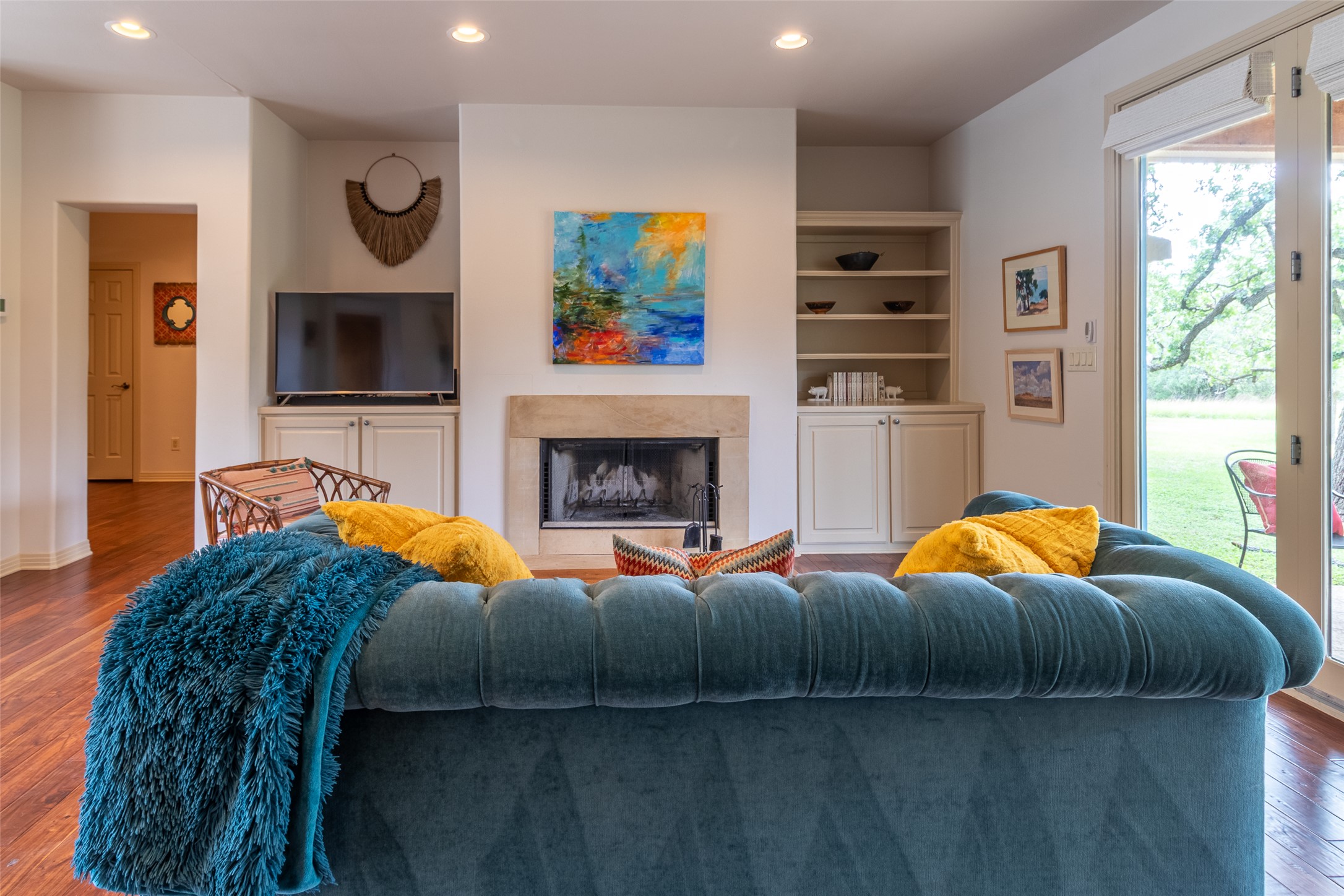 515 E Trail Spicewood, TX 78669 - Photo 19 of 36 a living room with furniture a flat screen tv and a fireplace