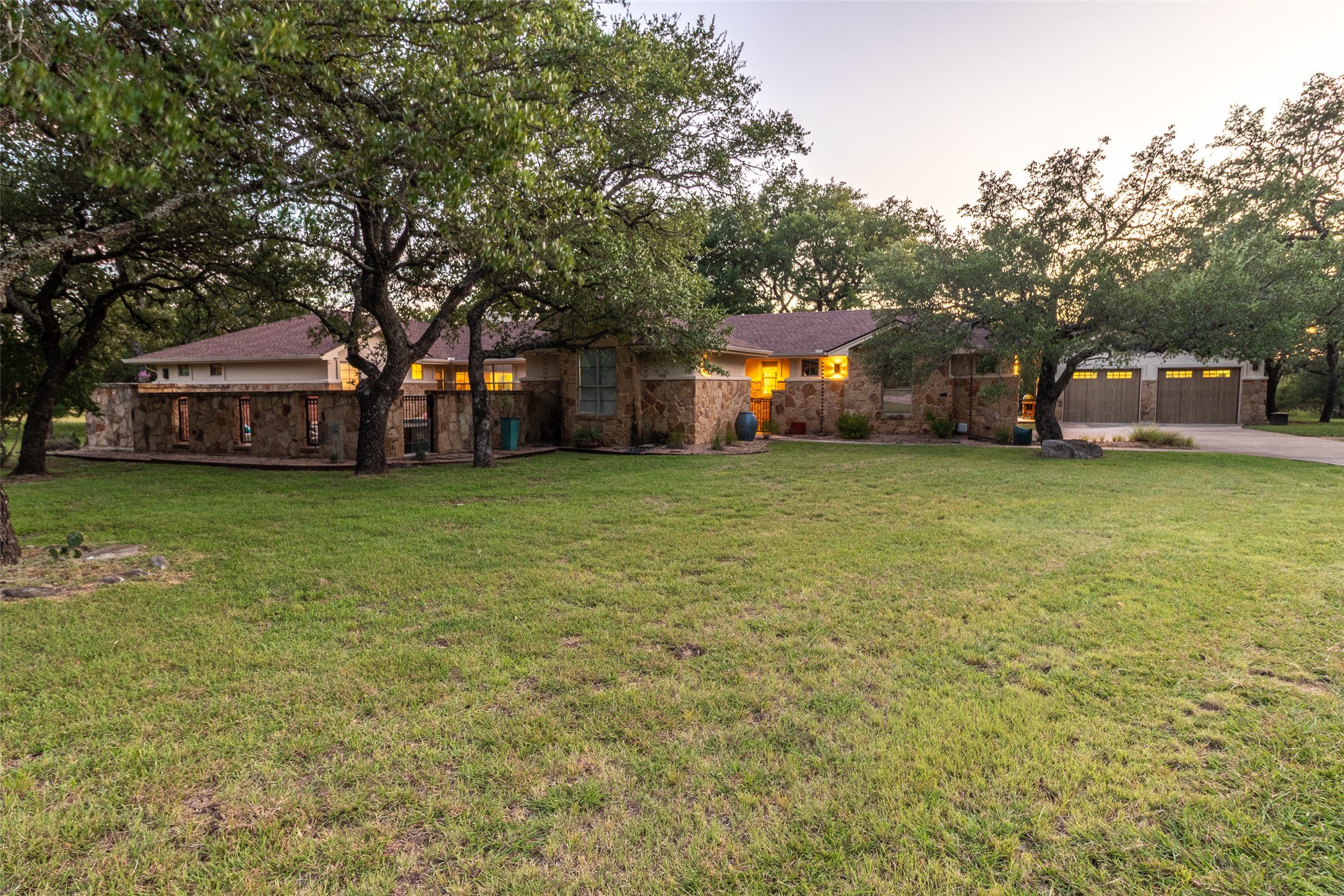515 E Trail Spicewood, TX 78669 - Photo 22 of 36 a view of a yard with a house and large trees