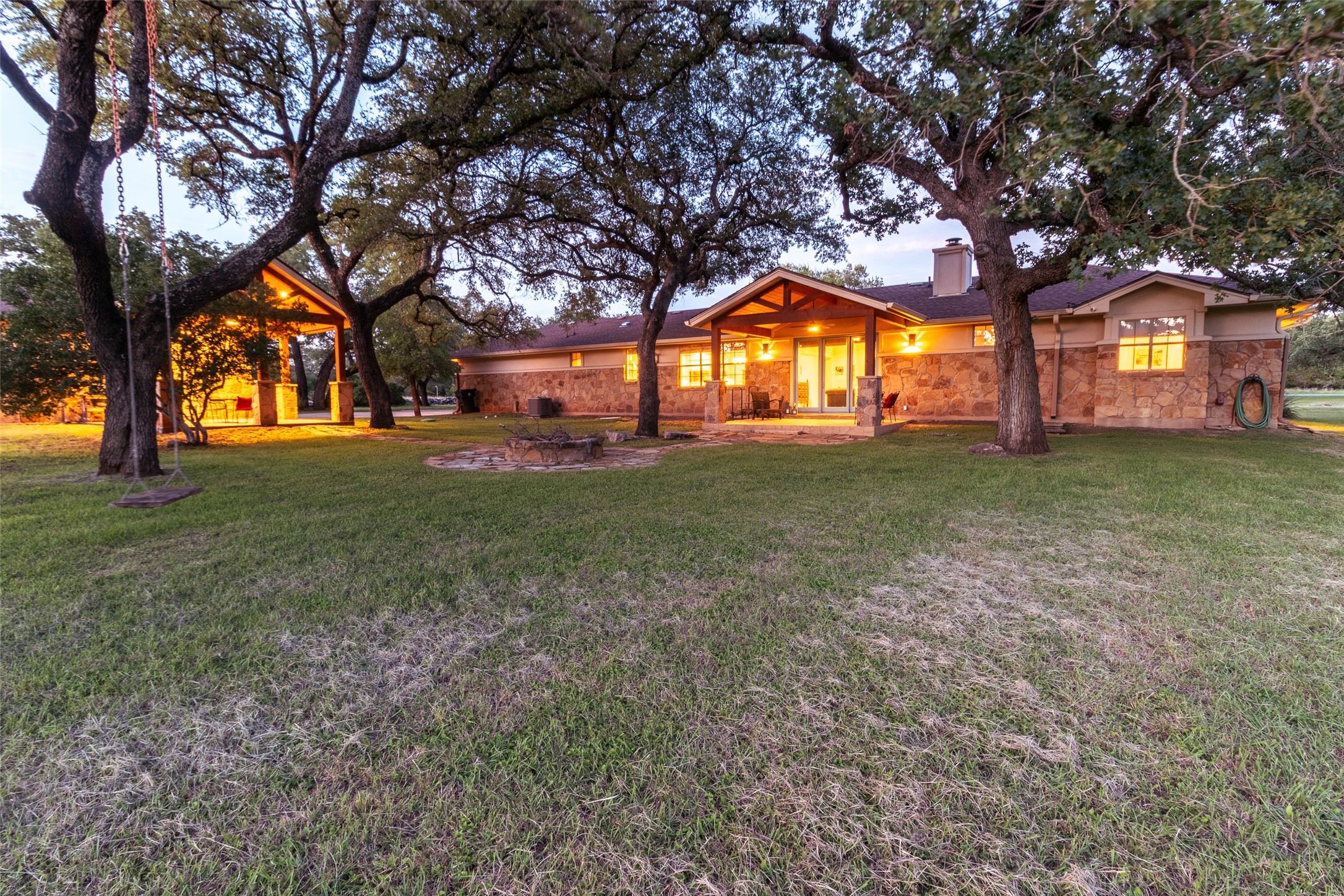 515 E Trail Spicewood, TX 78669 - Photo 26 of 36 a view of a house with a yard
