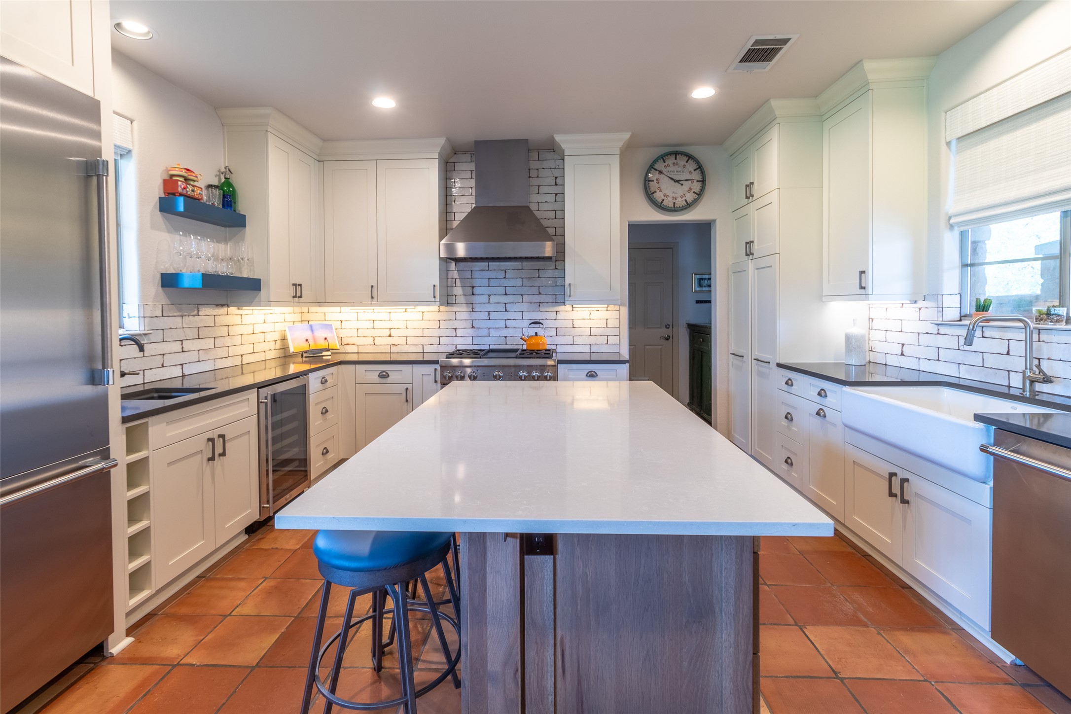 515 E Trail Spicewood, TX 78669 - Photo 27 of 36 a large kitchen with a table and chairs in it